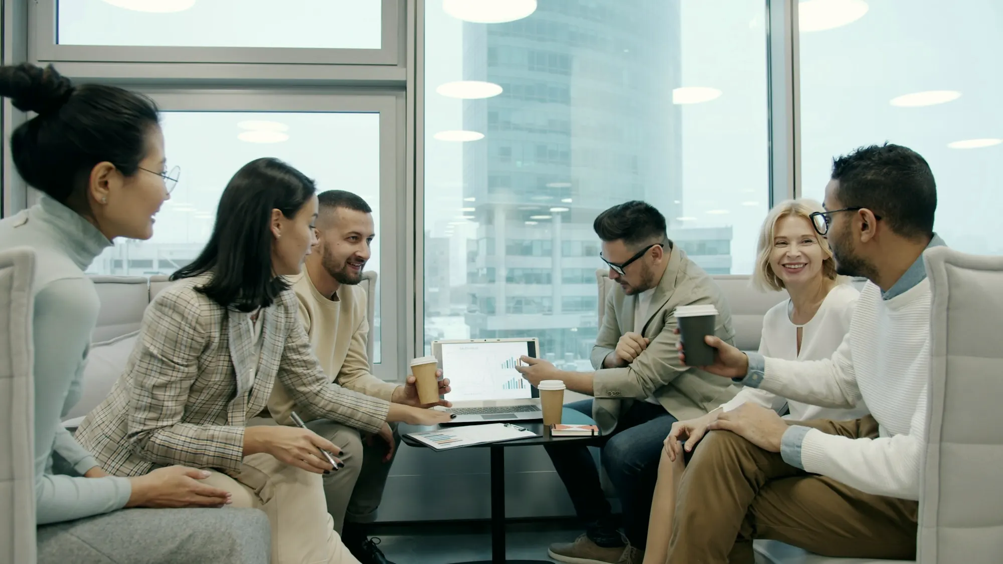 Colleagues discussing a plan around a meeting table