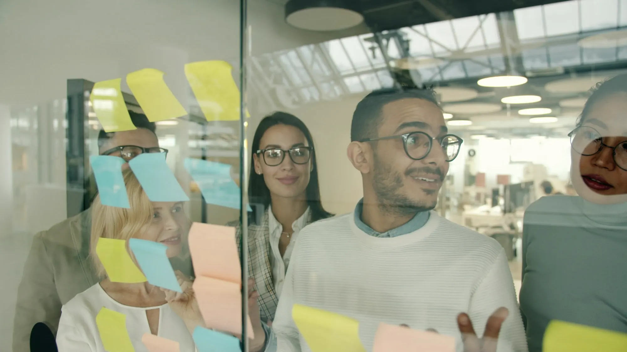 A team planning a programme together at a wall of sticky notes